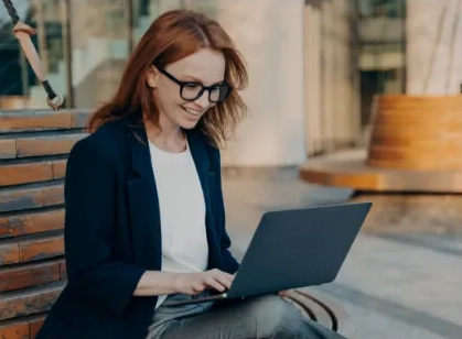 a student looks at a laptop